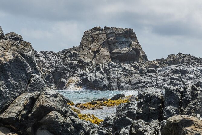 Aruba National Park Tour with Natural Pool & Baby Beach Snorkel - Conchi Natural Pool: a short swim in volcanic rock
